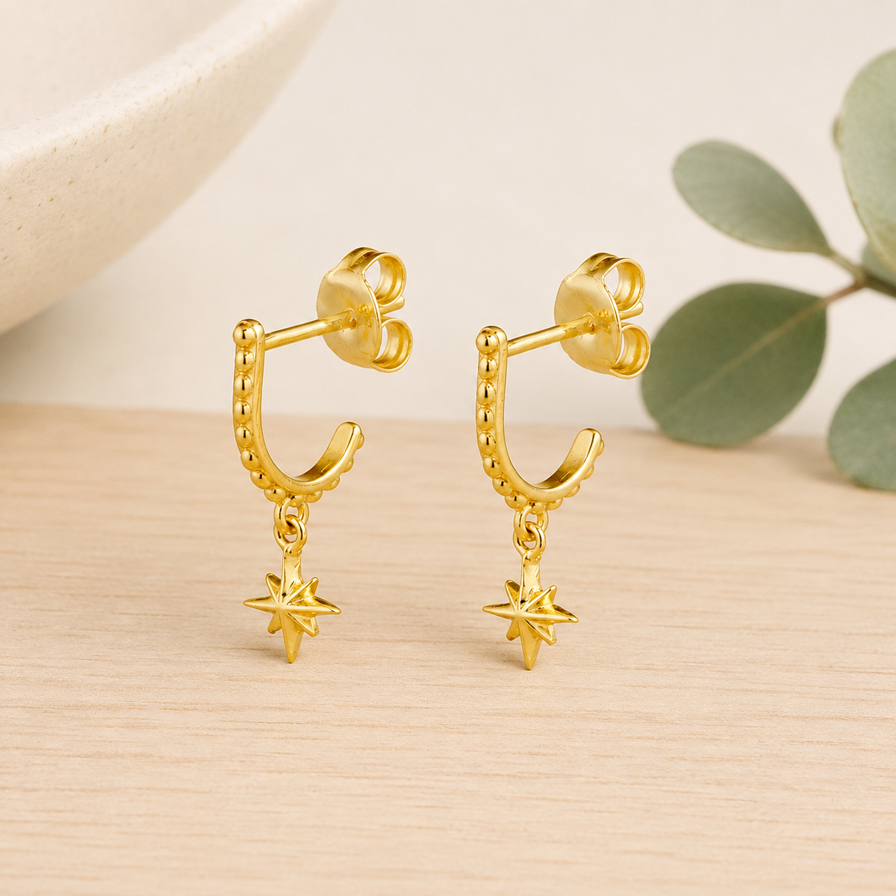 Gold North Star Huggie Earrings made from waterproof PVD gold plated stainless steel.