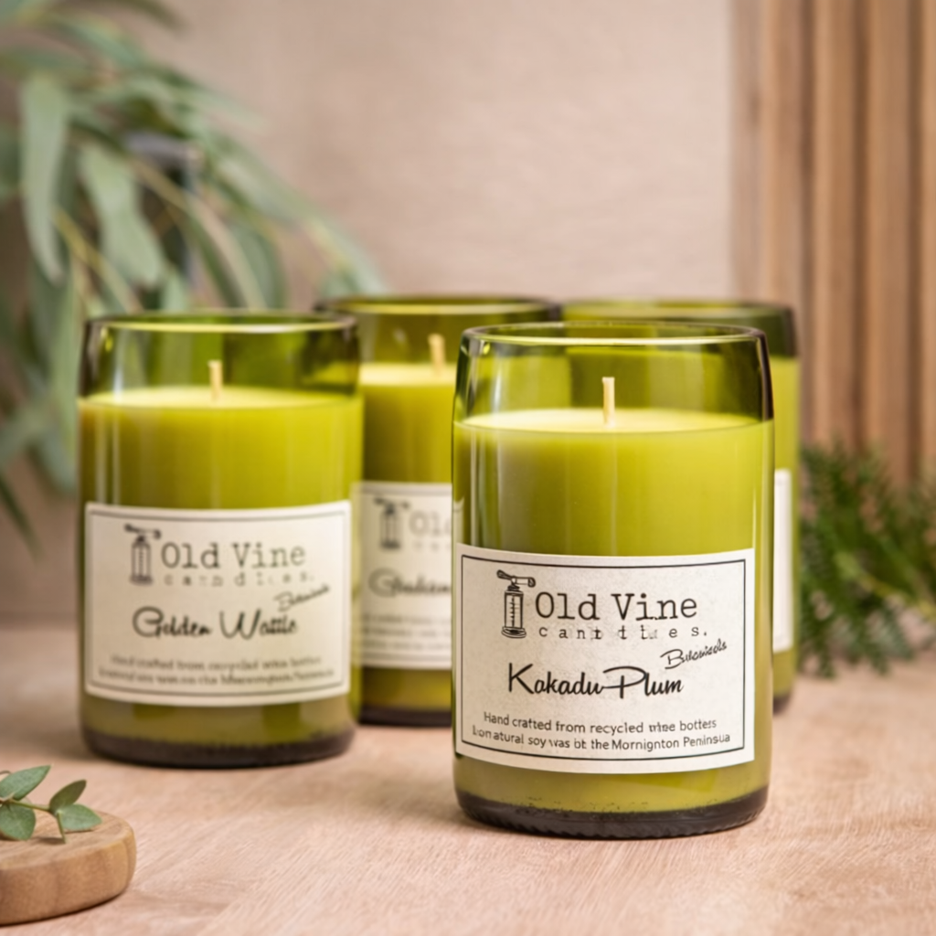 green wine bottle candles on light oak surface with soft neutral styling