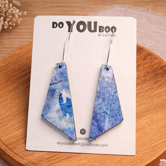 handmade blue abstract statement earrings with geometric shape on neutral background