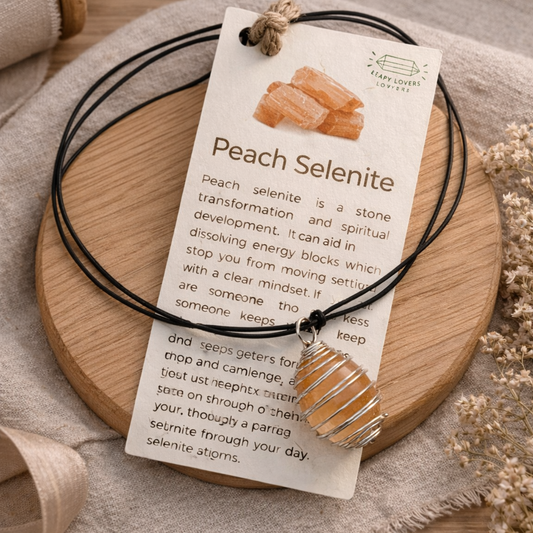 Peach selenite crystal necklace with wire wrapped pendant on neutral background