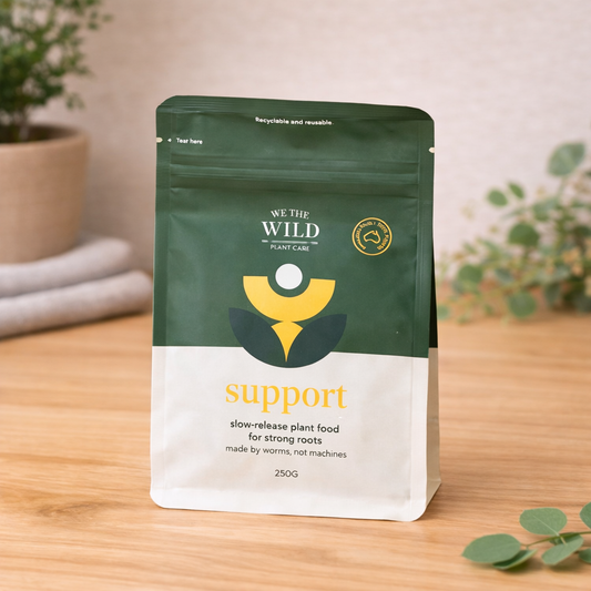 We The Wild support slow release plant pellets 250g on light oak background with natural styling
